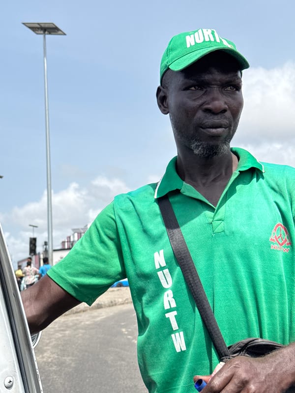 NURTW official photographed in green uniform in Ilado, Nigeria