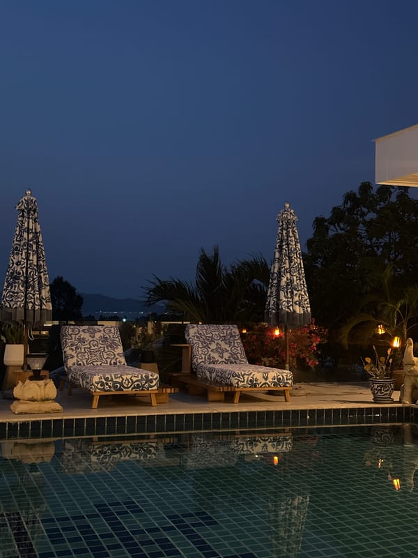Evening poolside scene and caged monkeys observed in Thailand