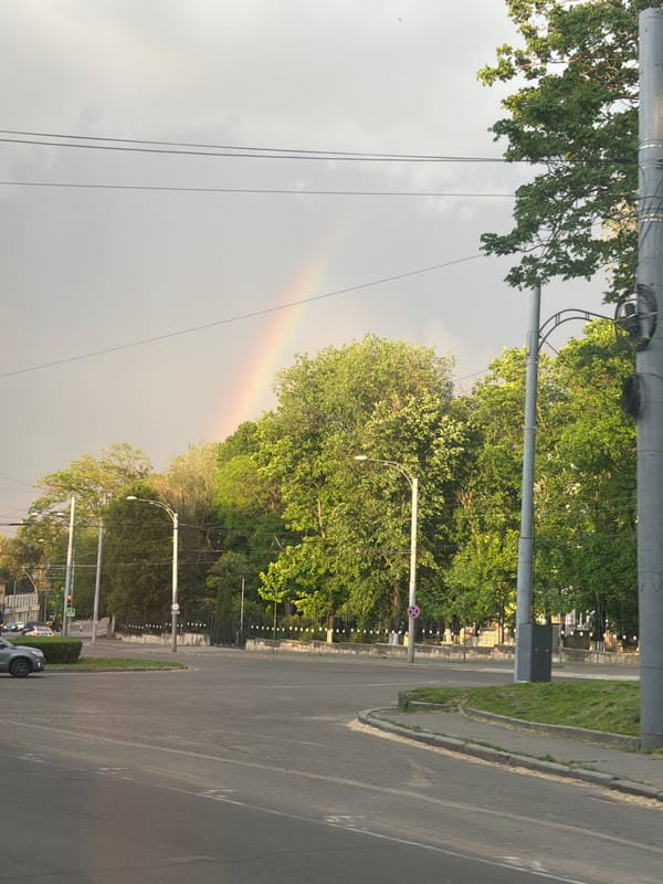 Rainbow appears over residential street in Codru, Moldova