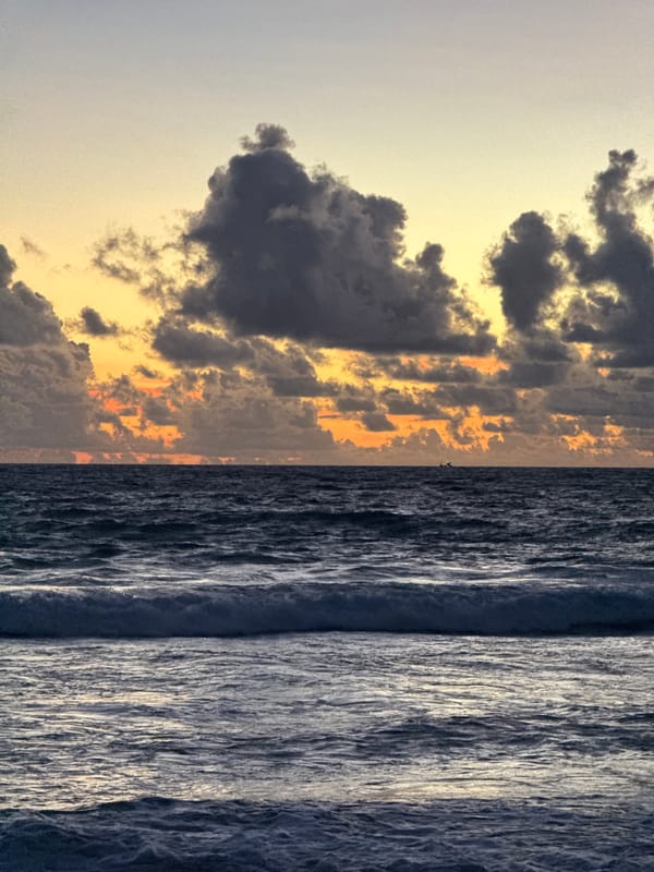 Dramatic sunset sky over a choppy Karon Beach