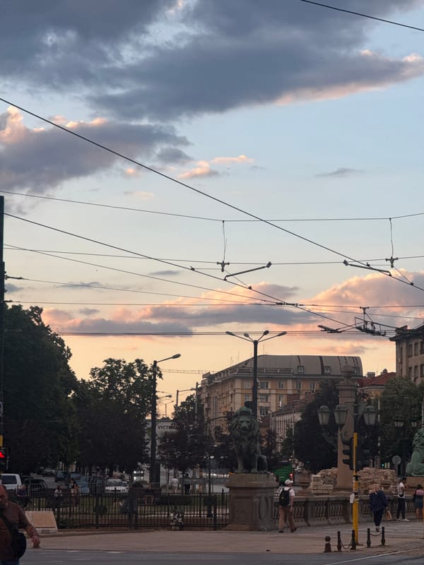 Evening streets of central Sofia, trams, clouds, and city life