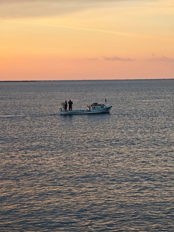 Three fishermen photographed at sunrise off Finike, Turkey