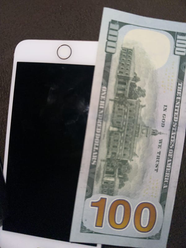 Yerevan witness documents $100 bill with phone and keys