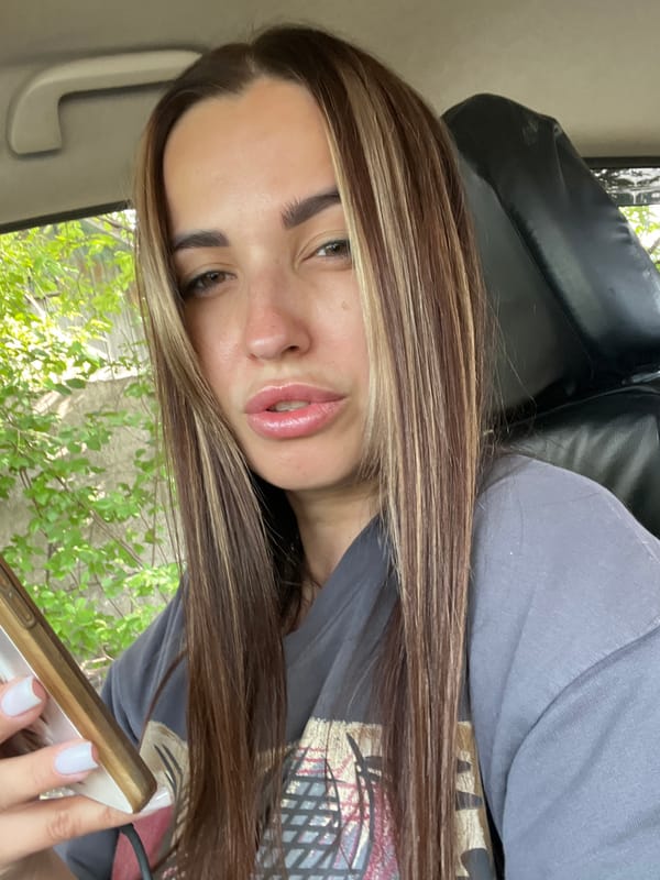 Quick selfie session inside a car, phone in hand