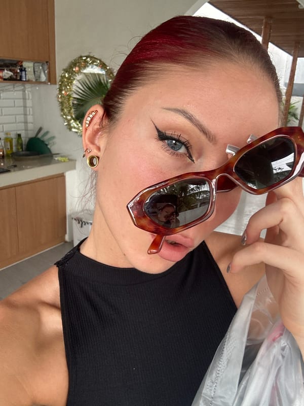 Woman poses with sunglasses indoors in North Kuta