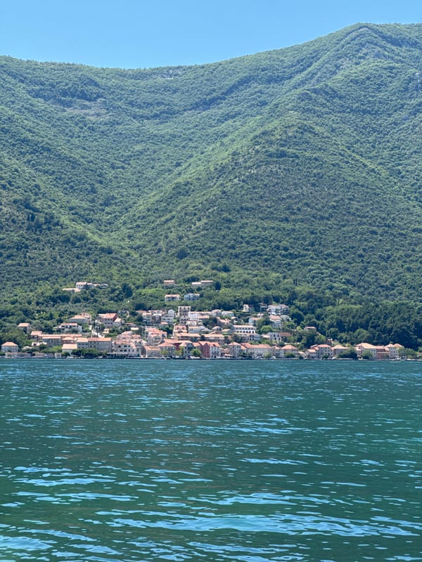 Man enjoys sunny morning by bay in Dobrota, Montenegro