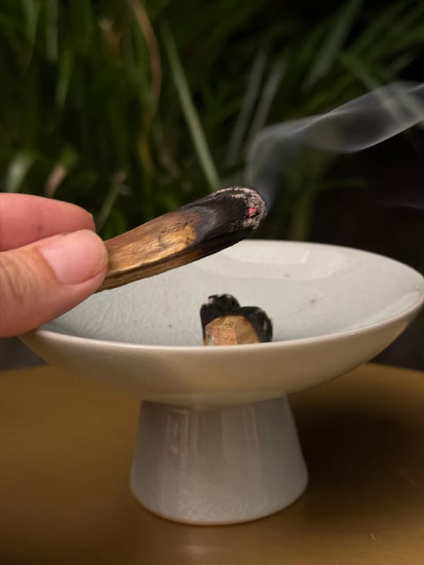 Palo santo burning ritual in a Ko Samui bedroom