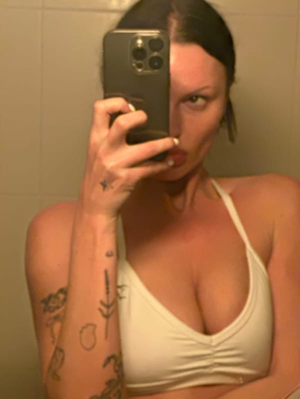 Woman takes mirror selfies in bathroom, Wealden UK