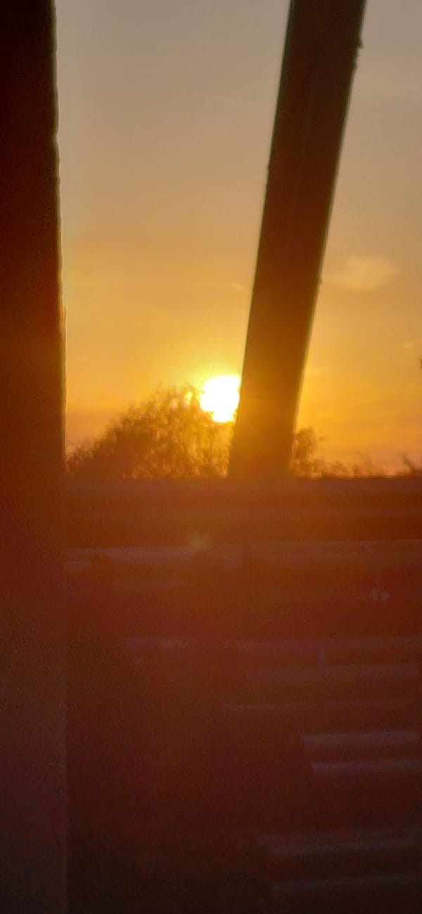 Sunset framed through glass and concrete at golden hour