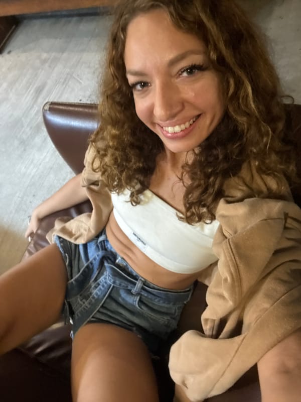 Woman in athletic wear sits indoors amid soccer decorations
