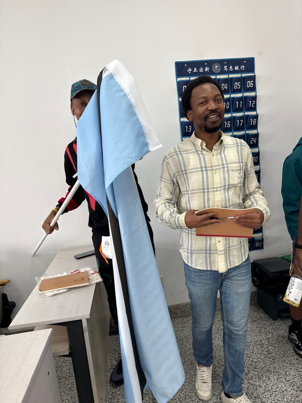 Group displays Botswana flag indoors in Beijing district