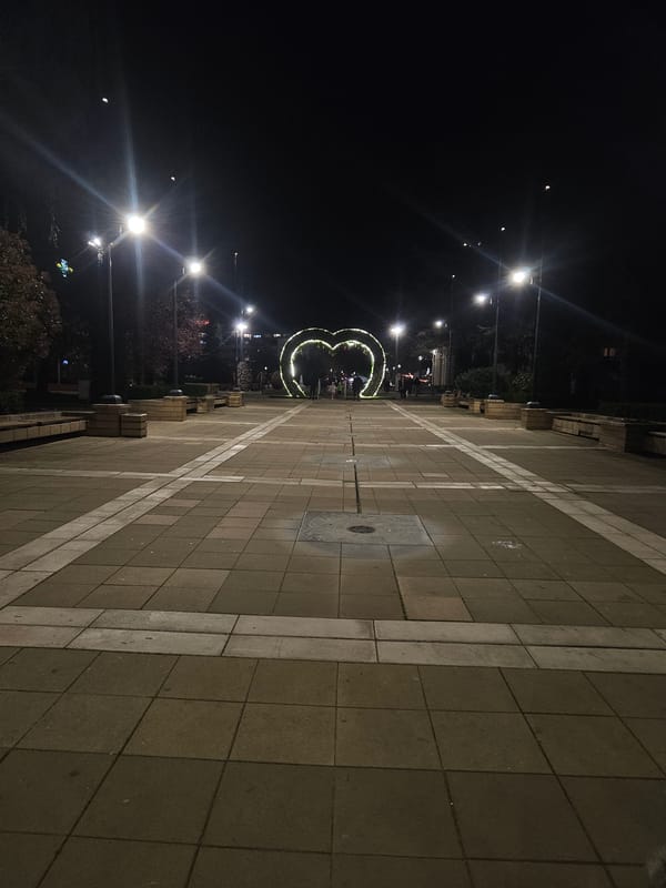 Evening stroll captured in Yambol plaza with illuminated decorations