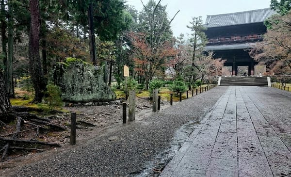 Wet stone pathway captured at Kyoto's Tofuku-ji Temple gate