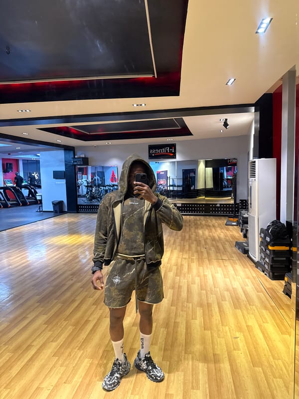 Gym mirror selfie in Lekki, camo fit.