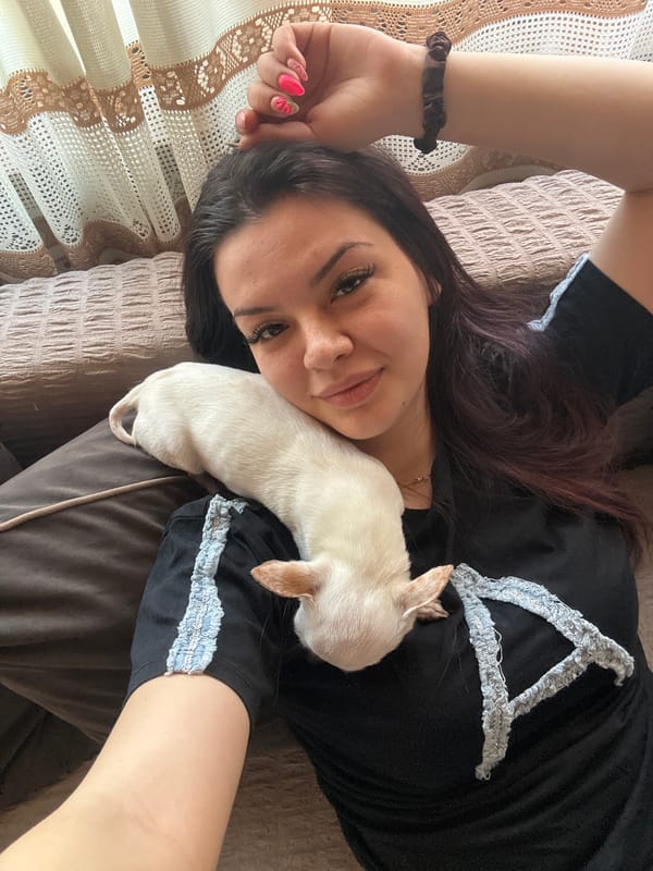 Woman photographed with small dog in Skala, Bulgaria