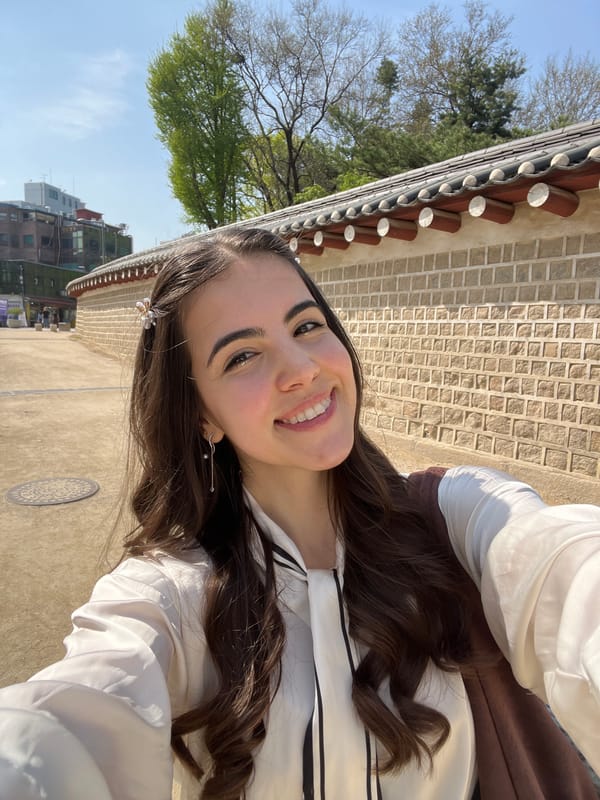 Woman takes morning selfies at traditional Seoul architecture