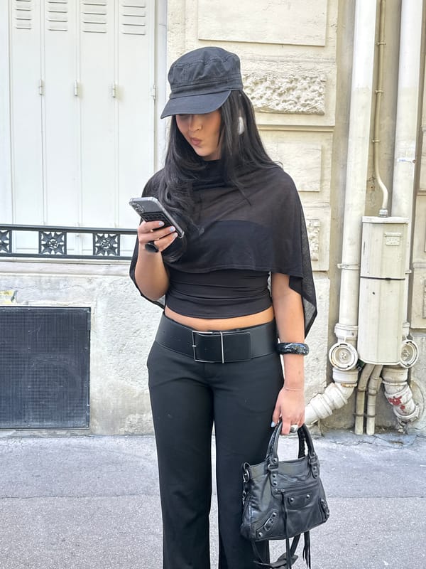 Paris street scenes: person in black, snake mural observed