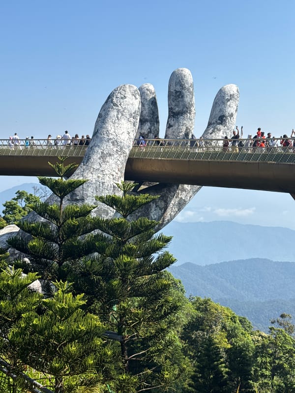 Tourists photograph iconic Golden Bridge and Buddha statue in Vietnam
