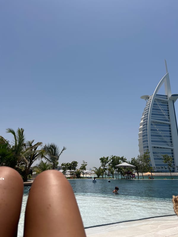 Morning swim captured at Dubai pool with Burj Al Arab backdrop