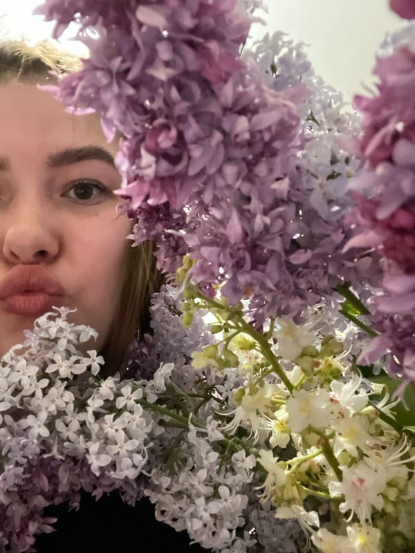 Person photographed beneath spring flowers in Novokuybyshevsk