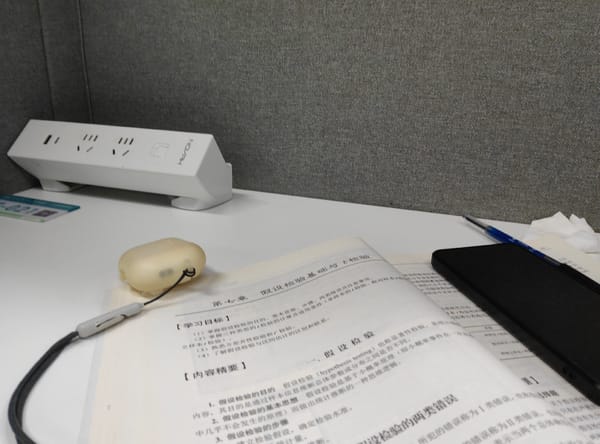 Late-night stats study session with textbook and phone