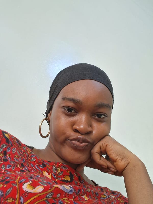 Woman in headscarf photographed near residential palm-lined neighborhood