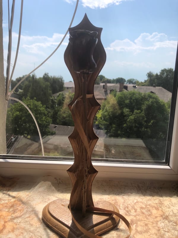 Ornate dark brown candle holder on a patterned surface