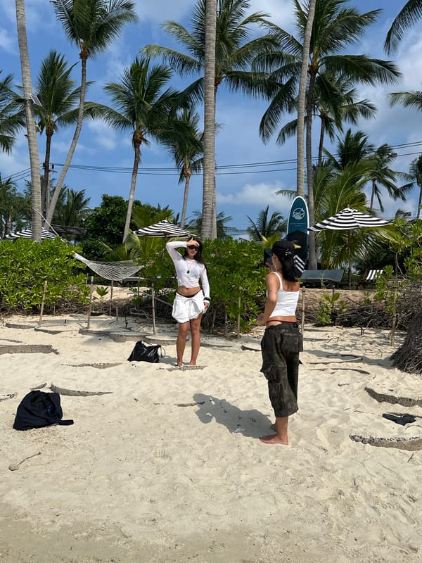 Two beachgoers enjoy sunny morning at Baan Tai, Thailand