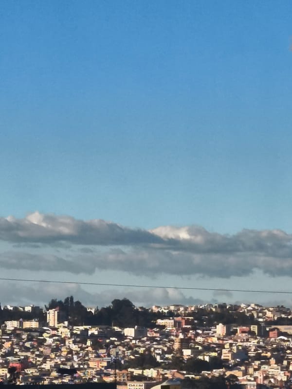 Evening cityscape photos document Quito's urban density under moonlit sky