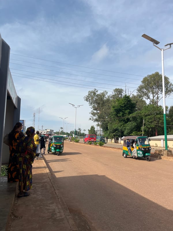 Morning street activity along a main road in Bukuru, Nigeria