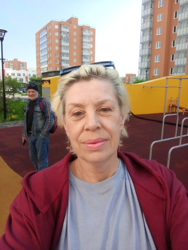 Couple photographs each other at Kommunar playground early morning
