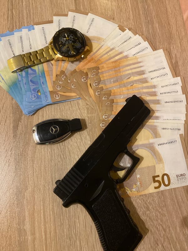 Luxury items including euros and gold watch documented