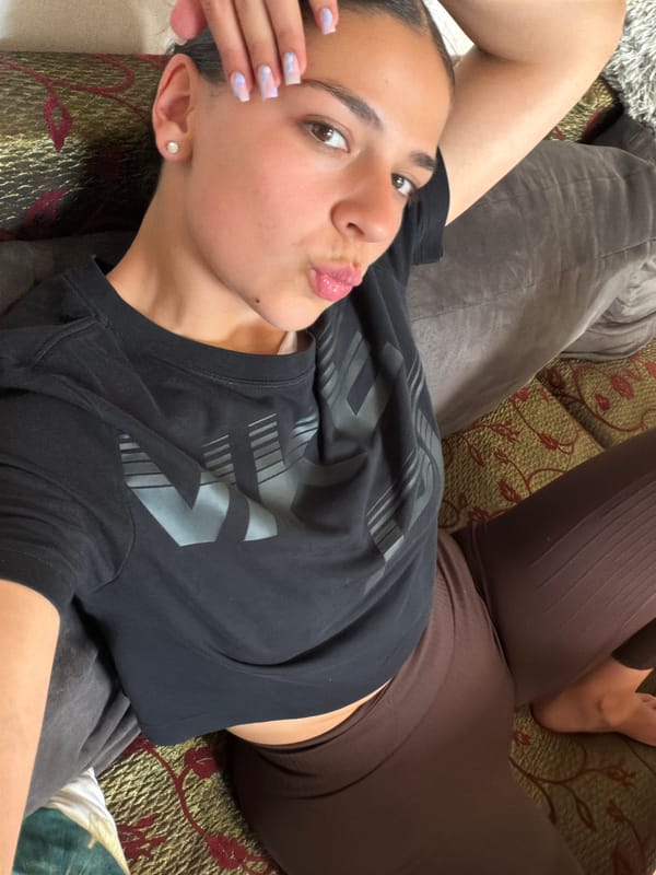 Woman takes playful selfies on couch in Gabrovo