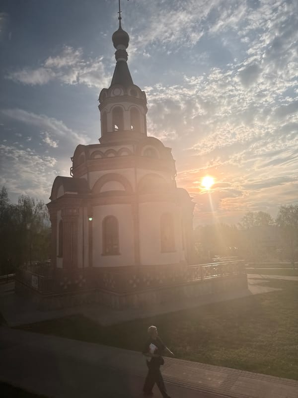 Church of Nativity photographed amid sunlit trees in Dmitrov