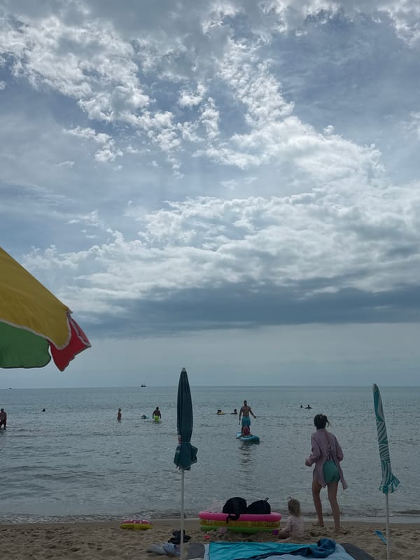 Cloudy beach morning in Nesebar with a green drink in hand