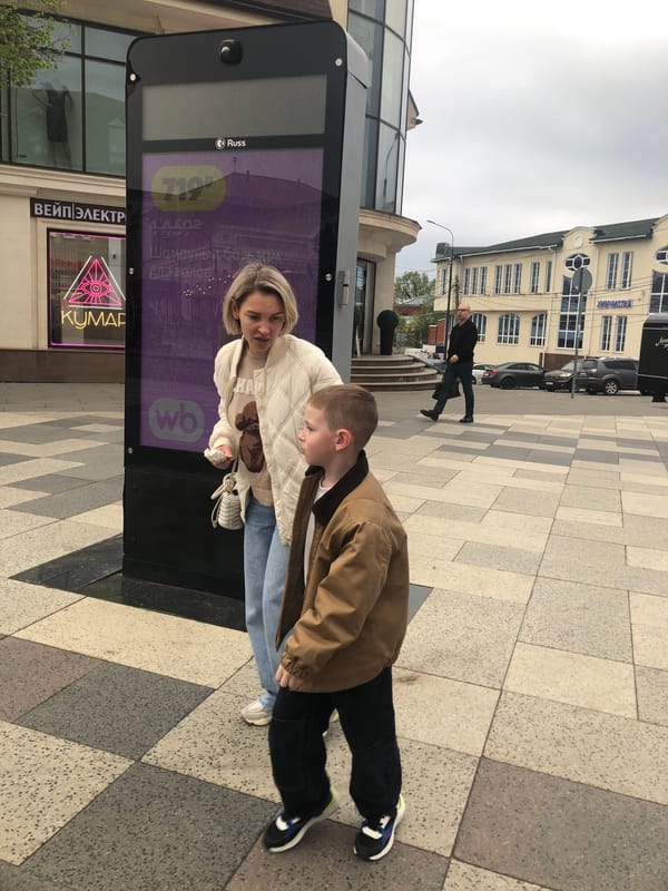 Everyday street life captured in unidentified Eastern European city plaza