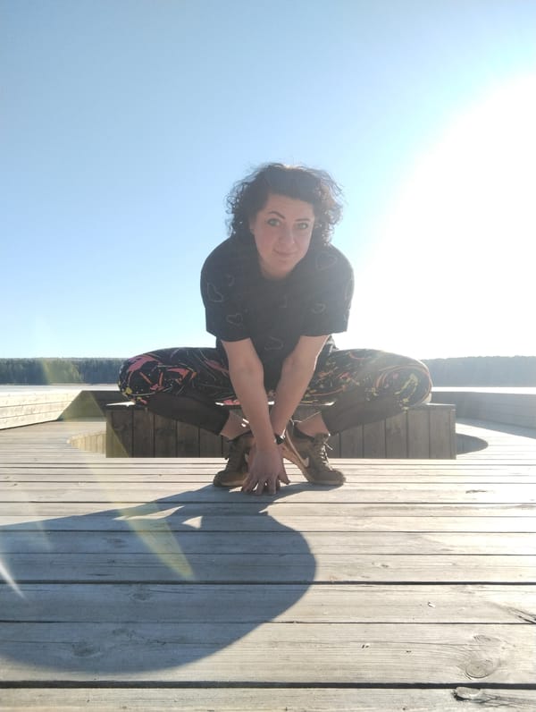 Woman enjoys sunny afternoon on lakeside deck in Votkinsk