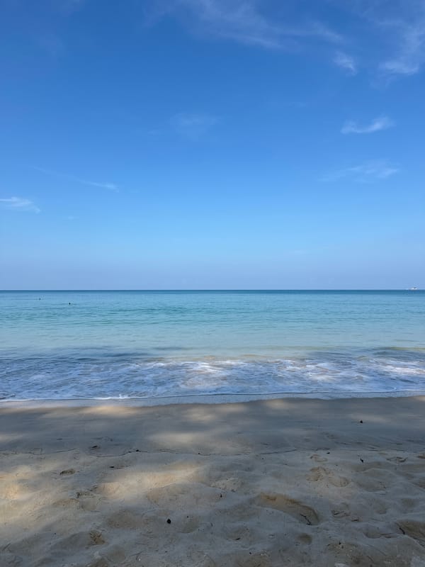 Woman sunbathes peacefully at Bang Tao Beach, Thailand