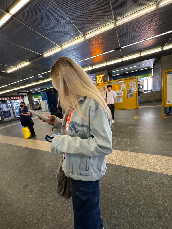 Blonde woman in denim jacket spotted across Milan locations