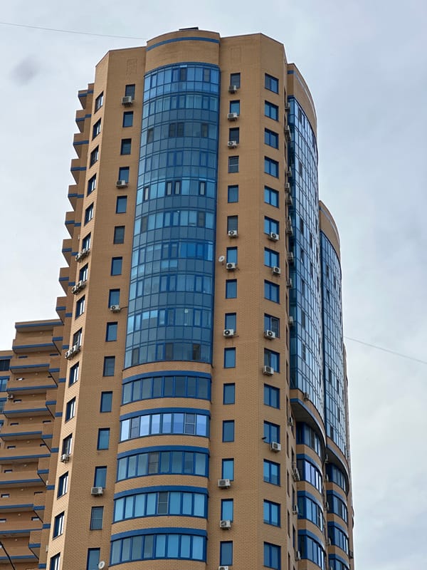 Modern building with blue glass facade observed in Reutov