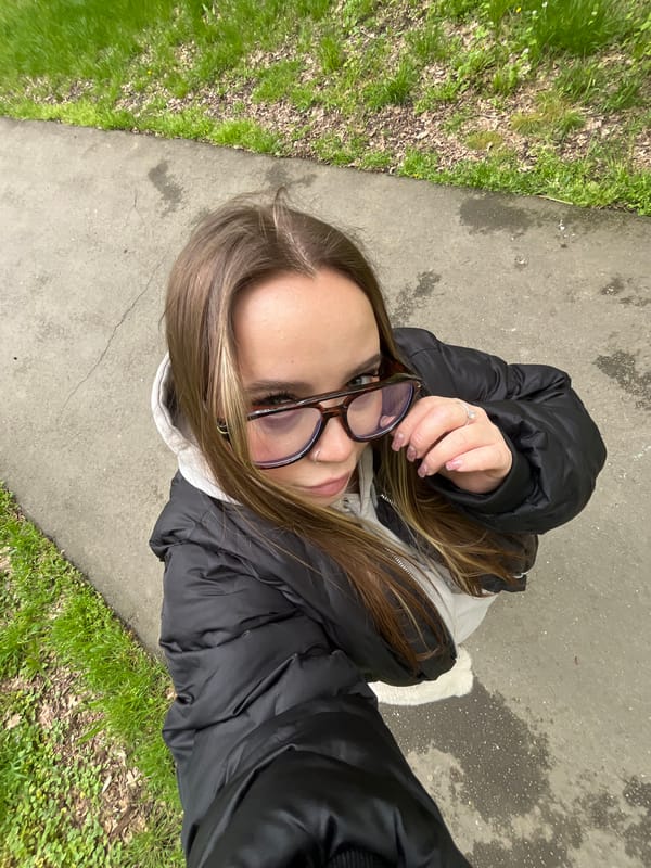 Woman poses for selfies in Krasnodar park during spring outing