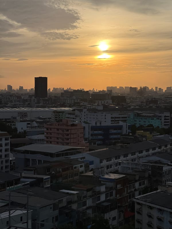 Bangkok skyline and canals at golden hour from above
