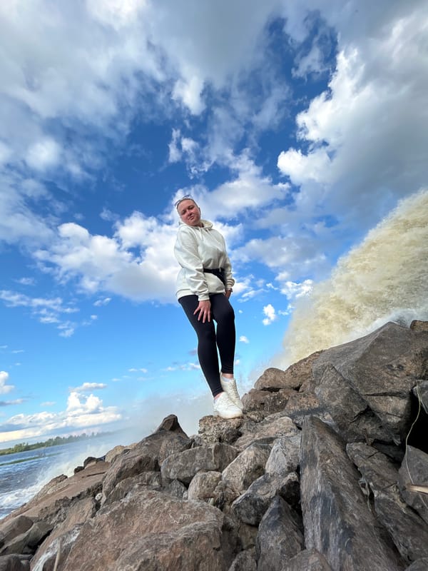 Tourists photograph waterfall visit in Chernushka, Russia