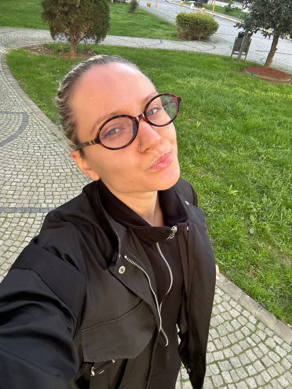 Woman drinks green liquid with eye patches in Turkish kitchen