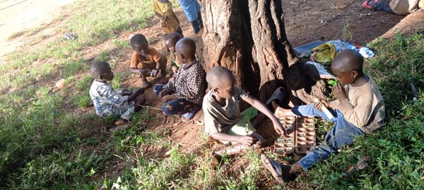 Children gather outdoors with adult in Ngalula, DRC