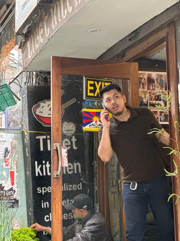 Street-level activity around Tibet Kitchen on a busy urban block