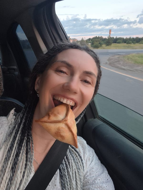 Snacking on a pastry in a car in Gol'yany, Russia