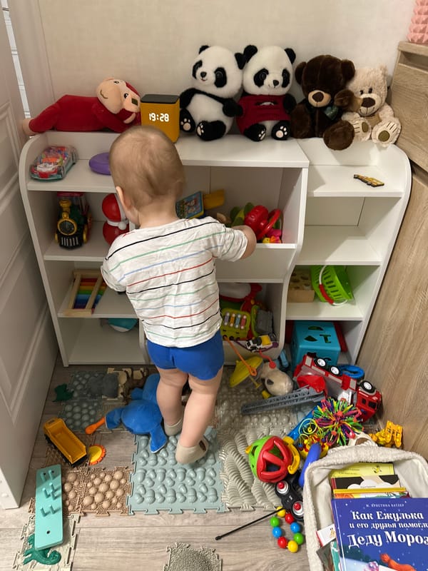 Toddler plays with books and toys in Lopatino playroom