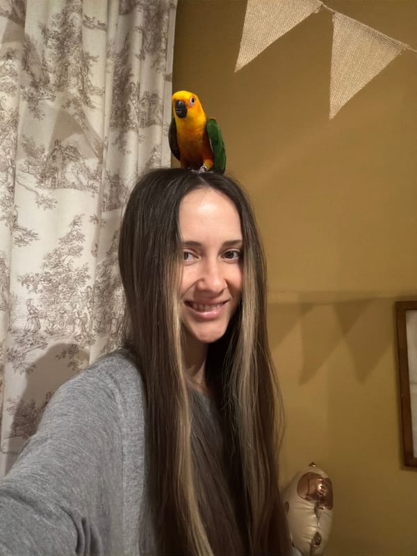 Woman photographed smiling with parrot perched on head in Khimki