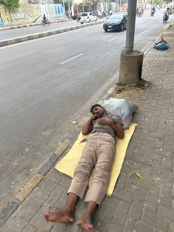 Sleeping on Karachi sidewalks on a July morning